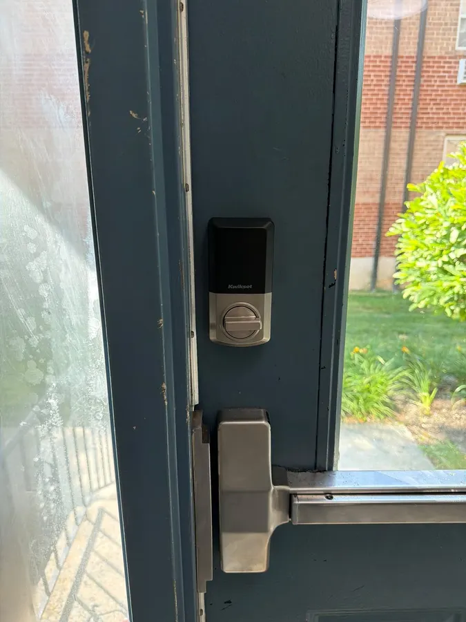 Storefront door with a panic bar and smart lock